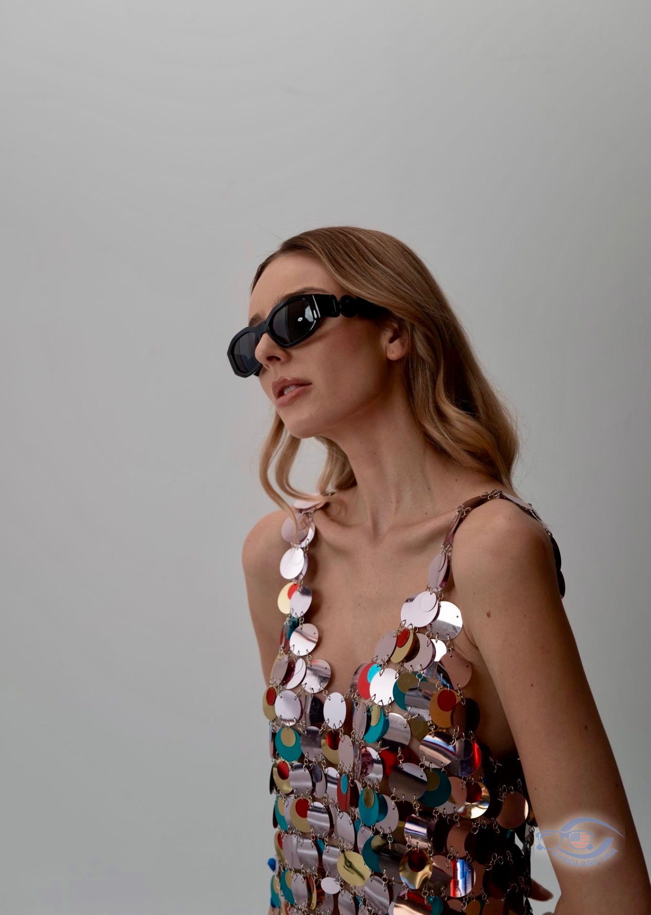 Customer in black oval designer sunglasses with metallic top
