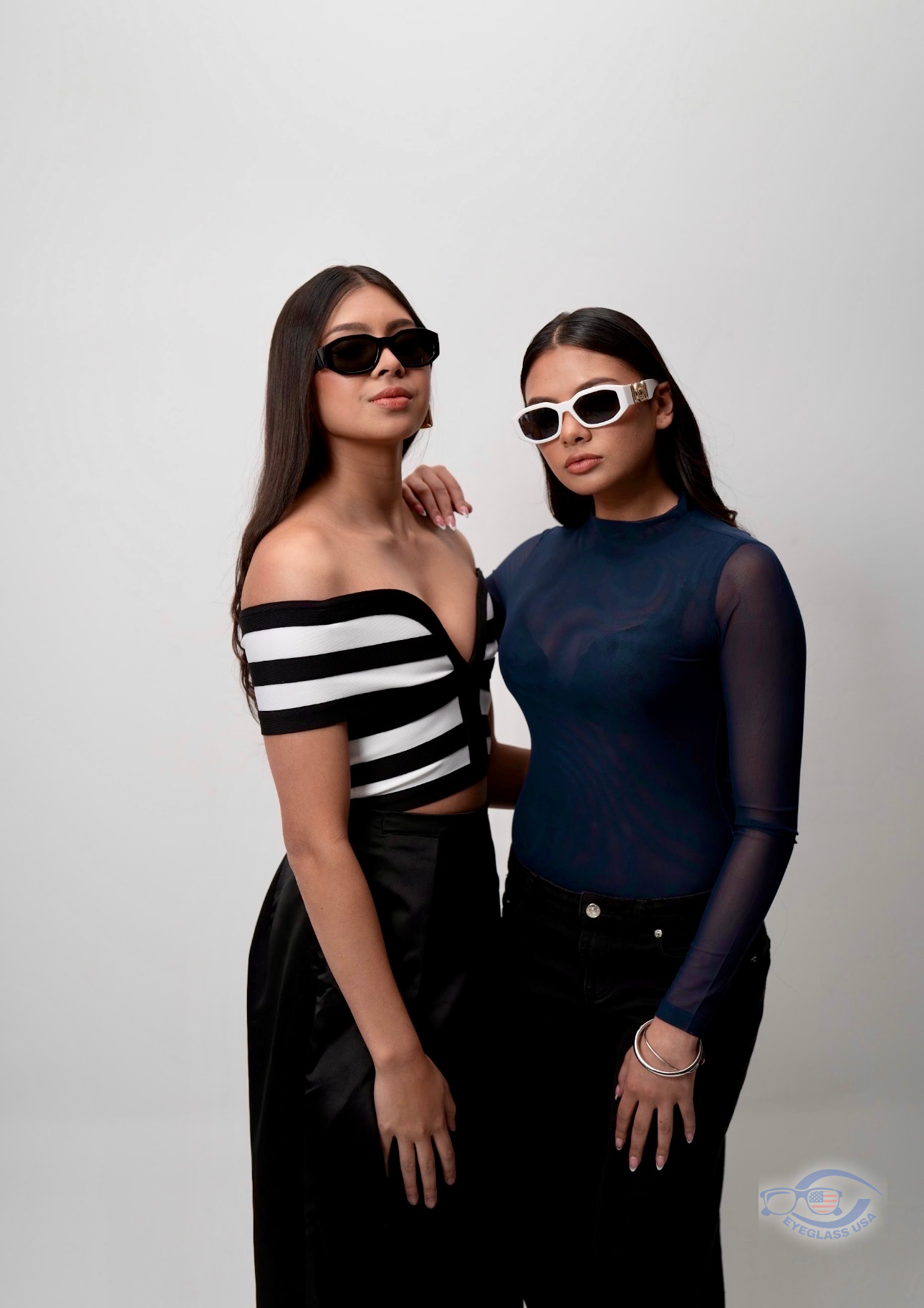 Two customers wearing designer sunglasses from Eyeglass USA