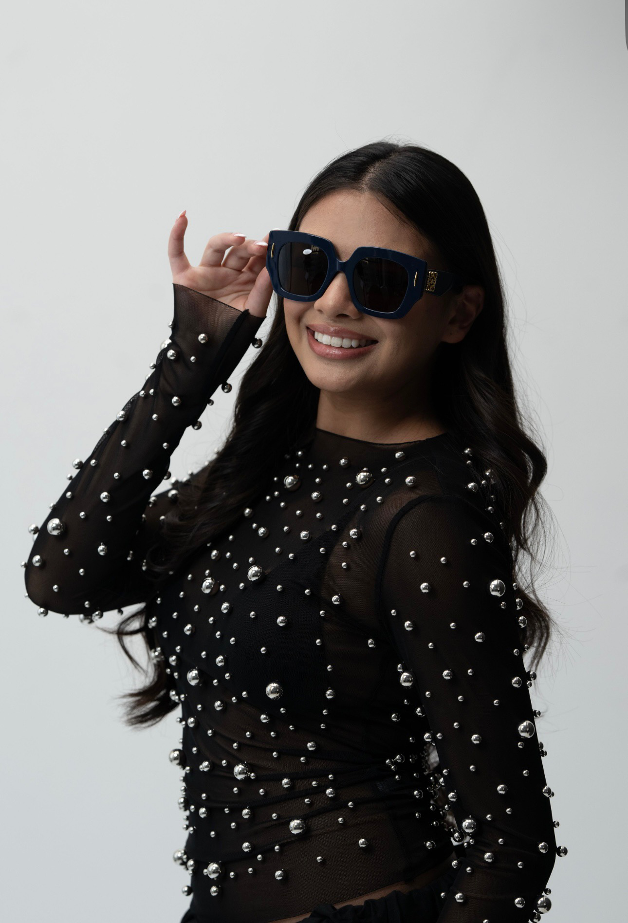 Smiling customer in navy square designer sunglasses
